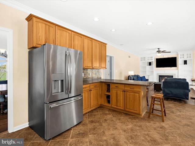 1121 Old Love Point Rd, Stevensville, MD 21666 - kitchen with stainless steel fridge with ice dispenser, dark countertops, crown molding, a peninsula, and ceiling fan