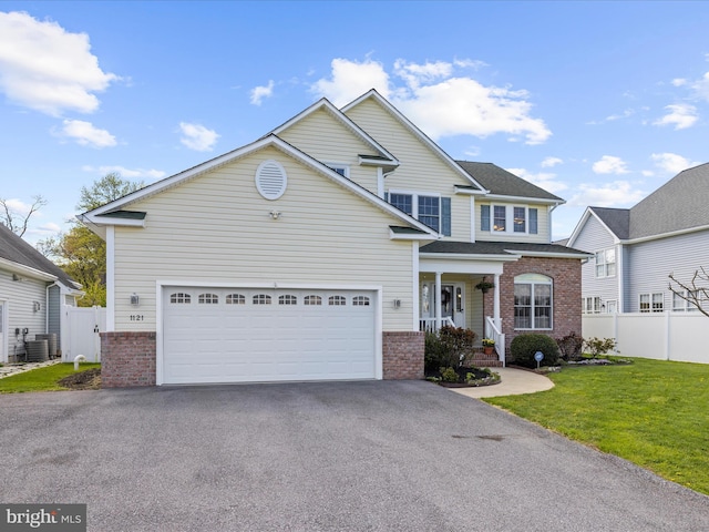 1121 Old Love Point Rd, Stevensville, MD 21666 - view of front of house featuring brick siding, aphalt driveway, and fence