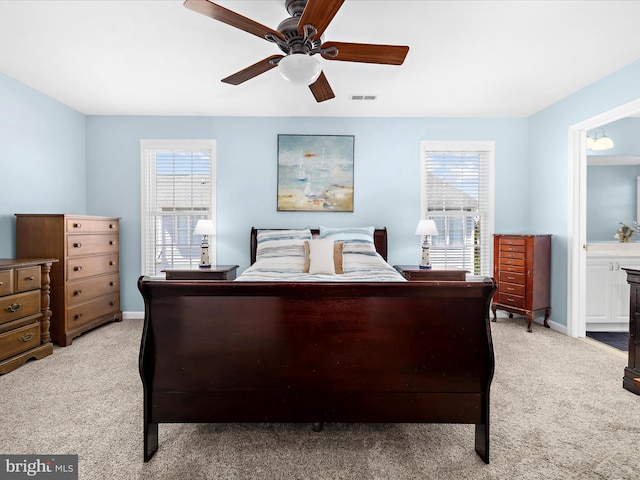 1121 Old Love Point Rd, Stevensville, MD 21666 - bedroom with ensuite bath, visible vents, baseboards, and light carpet