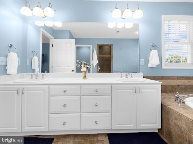 1121 Old Love Point Rd, Stevensville, MD 21666 - bathroom featuring tile patterned floors, a relaxing tiled tub, a sink, and double vanity