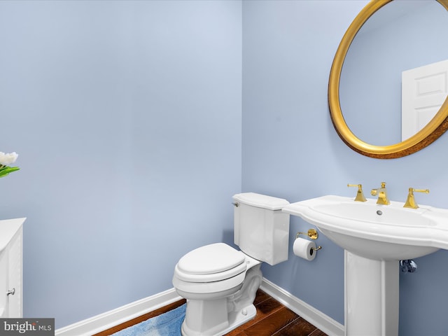 1121 Old Love Point Rd, Stevensville, MD 21666 - half bath with wood finished floors, toilet, and baseboards
