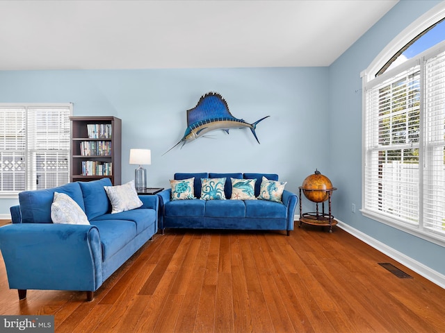 1121 Old Love Point Rd, Stevensville, MD 21666 - living room with wood finished floors, visible vents, and baseboards