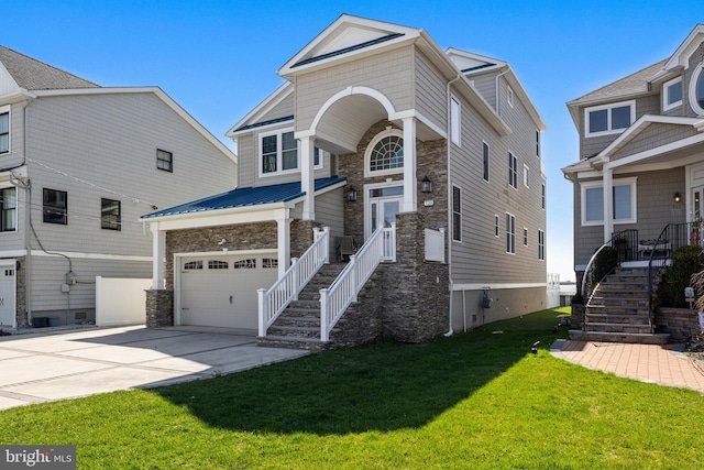 view of front of home featuring stone siding, a front yard, driveway, and stairs