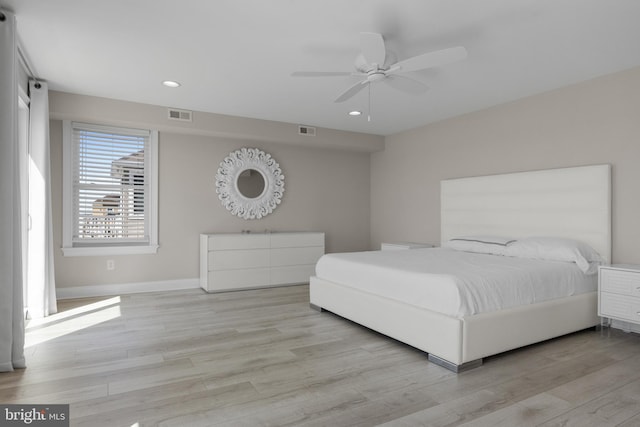 bedroom featuring light wood-style flooring, visible vents, and recessed lighting