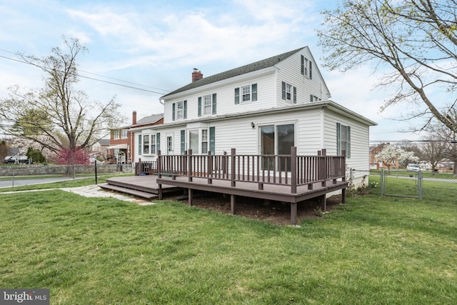 rear view of property featuring fence, a deck, a gate, a yard, and a chimney