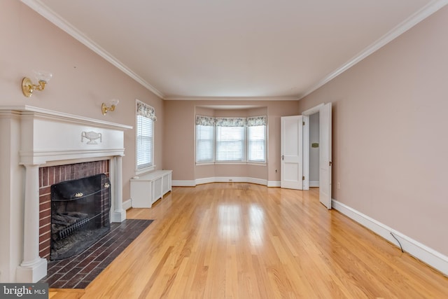 unfurnished living room featuring baseboards, ornamental molding, wood finished floors, and a brick fireplace