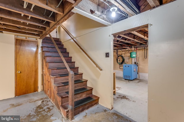 unfinished below grade area featuring stairway and a heating unit