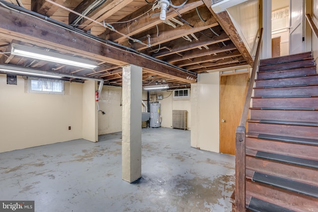 basement with water heater and stairs