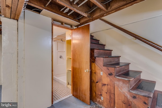 stairway featuring concrete flooring