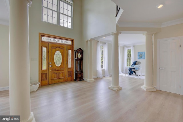 8177 Bodkin Ave, Pasadena, MD 21122 - foyer entrance with baseboards, decorative columns, ornamental molding, and light wood-type flooring