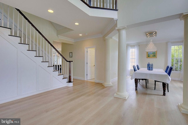 8177 Bodkin Ave, Pasadena, MD 21122 - foyer featuring stairway, crown molding, decorative columns, and wood finished floors