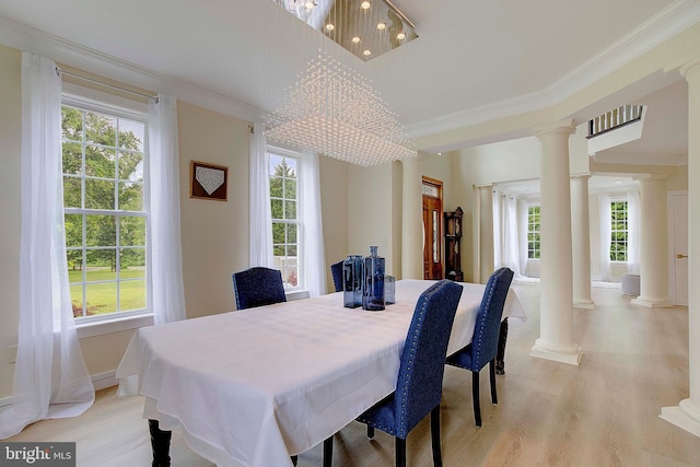 8177 Bodkin Ave, Pasadena, MD 21122 - dining area with light wood finished floors, ornate columns, and a wealth of natural light