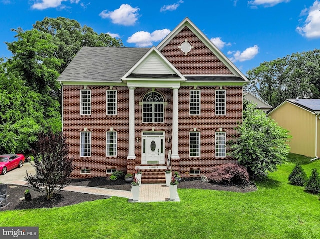 8177 Bodkin Ave, Pasadena, MD 21122 - view of front of house with a front yard and brick siding