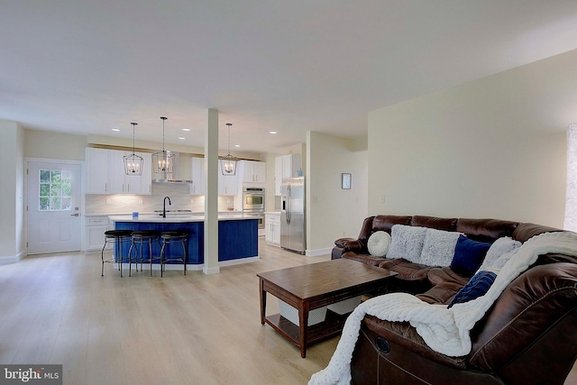 8177 Bodkin Ave, Pasadena, MD 21122 - living room with recessed lighting, baseboards, and light wood-type flooring
