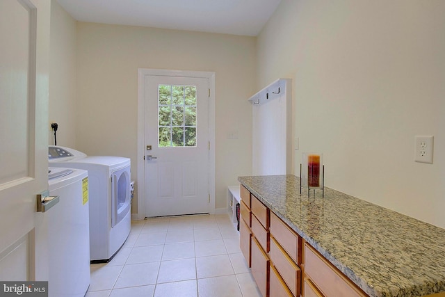 8177 Bodkin Ave, Pasadena, MD 21122 - clothes washing area featuring baseboards, cabinet space, light tile patterned flooring, and independent washer and dryer