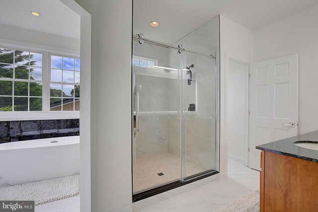 8177 Bodkin Ave, Pasadena, MD 21122 - bathroom with recessed lighting, a soaking tub, and a shower stall