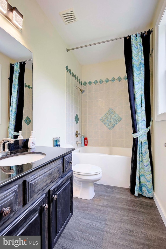 8177 Bodkin Ave, Pasadena, MD 21122 - full bath with shower / bath combination with curtain, visible vents, wood finished floors, vanity, and toilet