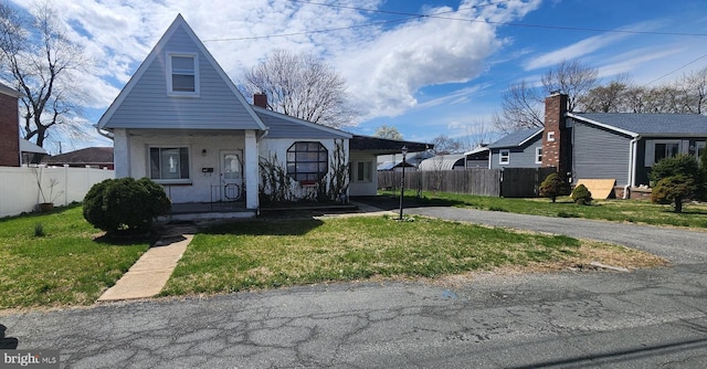 8323 Bear Creek Dr, Baltimore, MD 21222 - bungalow featuring fence, a front yard, and covered porch
