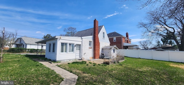 8323 Bear Creek Dr, Baltimore, MD 21222 - back of property featuring a lawn, fence, and a chimney