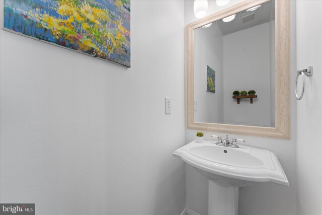 bathroom featuring a sink and visible vents