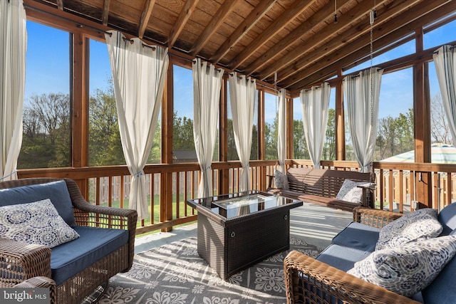 sunroom featuring vaulted ceiling