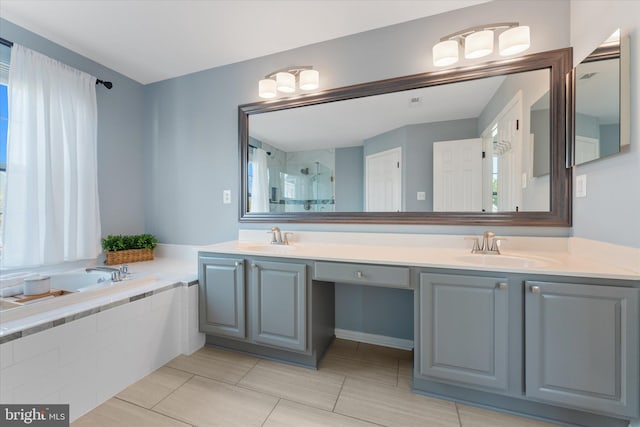full bathroom featuring a bath, a sink, a shower stall, and double vanity