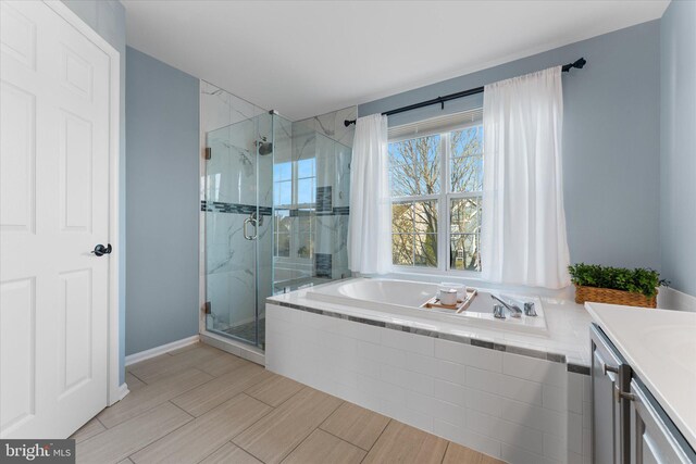 full bathroom with a garden tub, vanity, wood tiled floor, and a stall shower