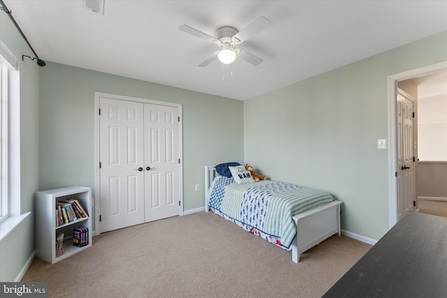 bedroom featuring baseboards, carpet, a closet, and ceiling fan