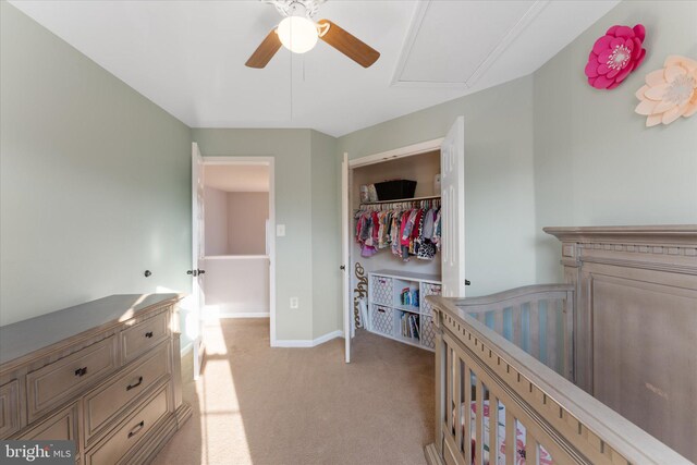bedroom featuring a closet, a ceiling fan, baseboards, and light carpet