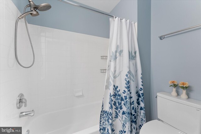 bathroom with shower / tub combo and toilet