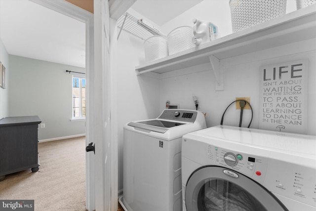 laundry room with washing machine and dryer, light carpet, laundry area, and baseboards