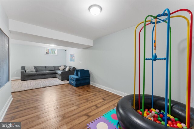 living room featuring wood finished floors and baseboards