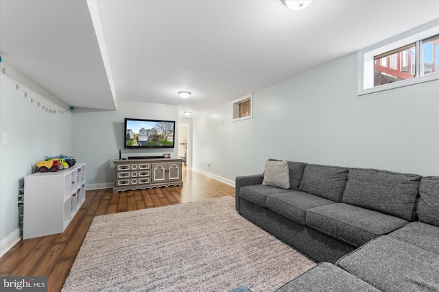 living room featuring baseboards and wood finished floors