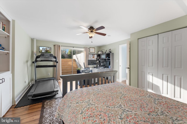 bedroom featuring baseboards, a ceiling fan, wood finished floors, and a closet