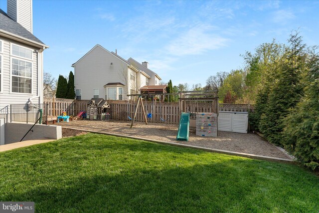 view of yard featuring a playground and fence