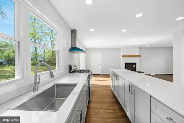 3 Amherst Dr, Newark, DE 19711 - kitchen featuring a sink, stainless steel gas range oven, wall chimney range hood, plenty of natural light, and recessed lighting