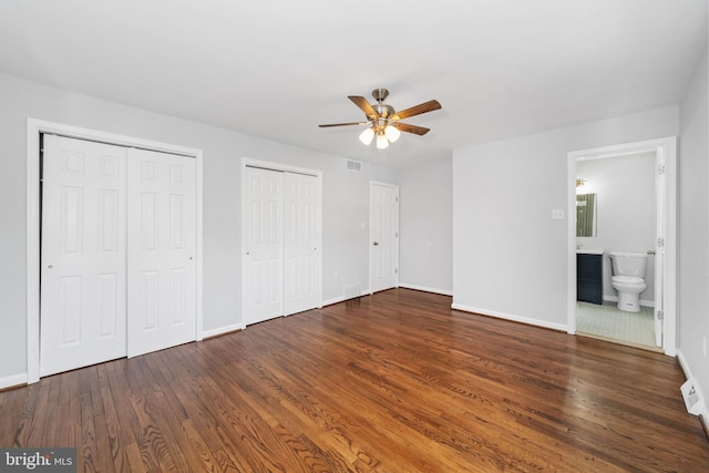 3 Amherst Dr, Newark, DE 19711 - unfurnished bedroom with multiple closets, baseboards, wood finished floors, a ceiling fan, and ensuite bath