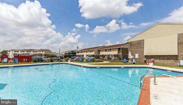 pool featuring a residential view and fence