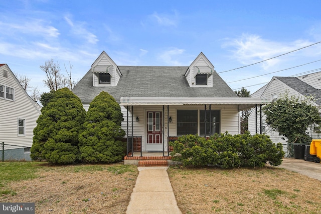 103 Cromwell Ave, Glen Burnie, MD 21061 - view of front of property featuring fence, a front yard, brick siding, a shingled roof, and a porch