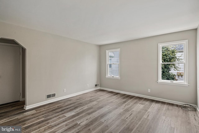 103 Cromwell Ave, Glen Burnie, MD 21061 - spare room featuring dark wood-style floors, visible vents, and plenty of natural light