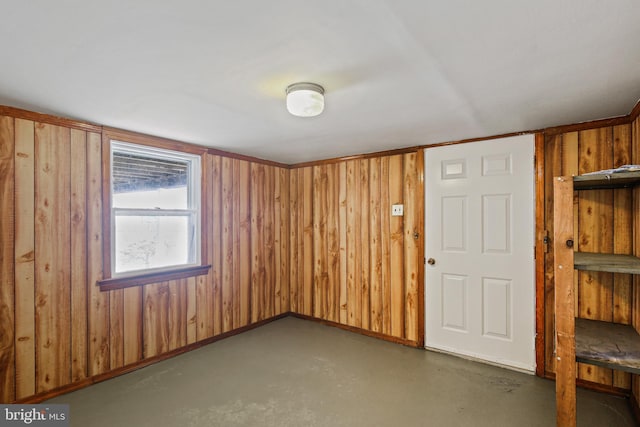 103 Cromwell Ave, Glen Burnie, MD 21061 - spare room featuring concrete floors, wood walls, and baseboards