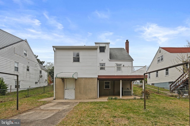 103 Cromwell Ave, Glen Burnie, MD 21061 - rear view of house with a chimney, cooling unit, a wooden deck, a fenced backyard, and a yard