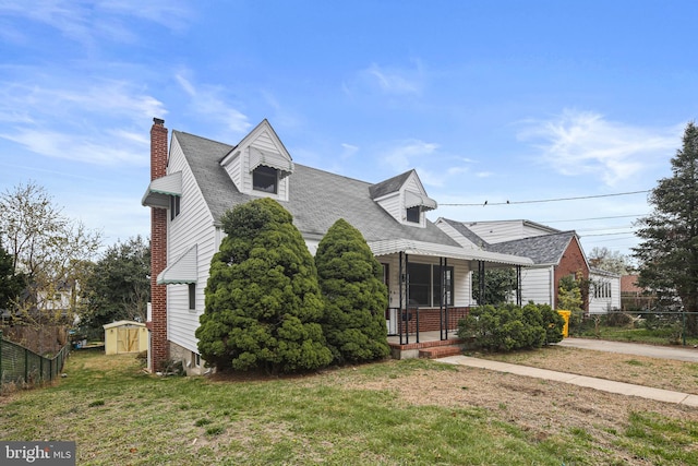 103 Cromwell Ave, Glen Burnie, MD 21061 - new england style home with a front yard, roof with shingles, a chimney, fence, and a porch
