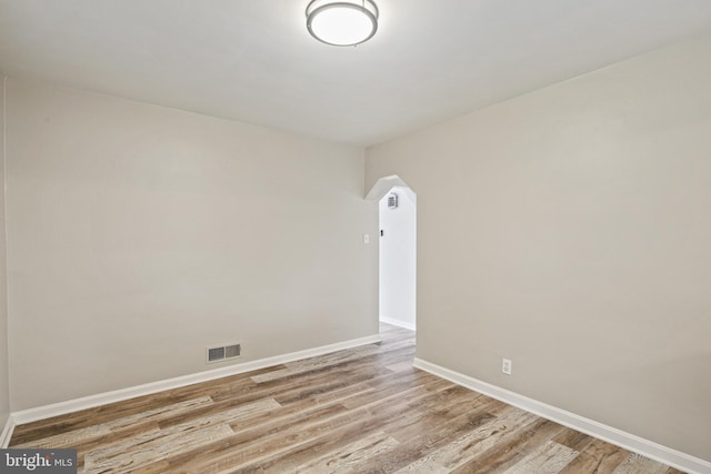 103 Cromwell Ave, Glen Burnie, MD 21061 - spare room with visible vents, arched walkways, baseboards, and wood finished floors