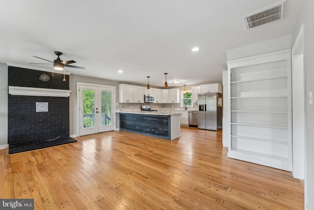 19316 Landora Bridge Rd, Ruther Glen, VA 22546 - kitchen with appliances with stainless steel finishes, healthy amount of natural light, white cabinetry, a peninsula, and recessed lighting