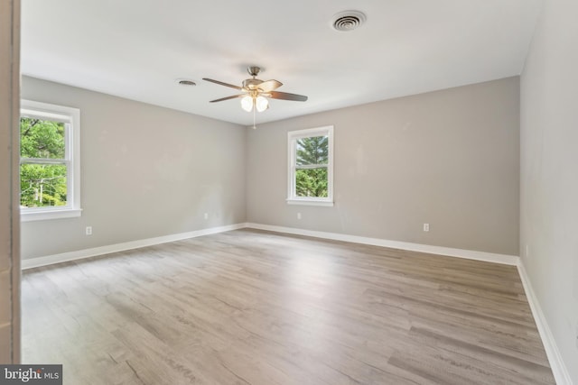 19316 Landora Bridge Rd, Ruther Glen, VA 22546 - empty room with healthy amount of natural light, light wood-style floors, ceiling fan, and baseboards