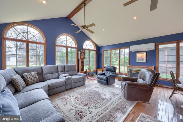 3902 Reiff Pl, Reading, PA 19606 - living room featuring a wall mounted AC, high vaulted ceiling, beam ceiling, hardwood / wood-style flooring, and a ceiling fan