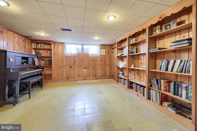 3902 Reiff Pl, Reading, PA 19606 - living area with visible vents, wooden walls, light floors, and built in shelves