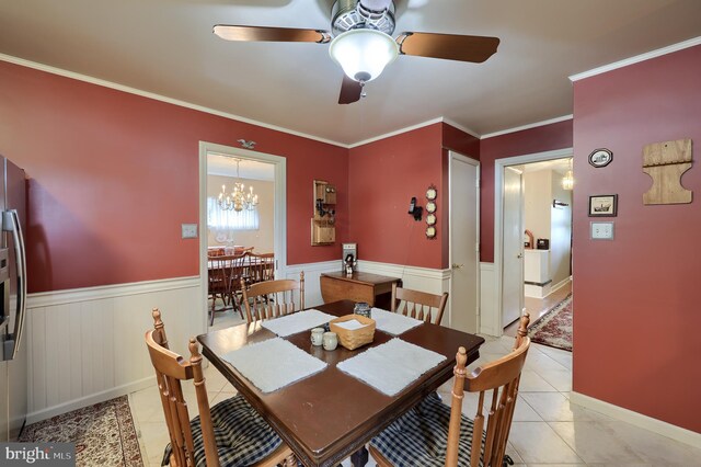 3902 Reiff Pl, Reading, PA 19606 - dining room with ceiling fan with notable chandelier, wainscoting, ornamental molding, and light tile patterned floors