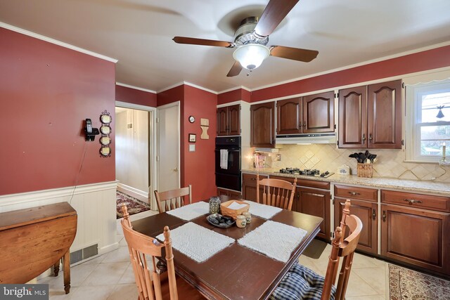 3902 Reiff Pl, Reading, PA 19606 - dining area with wainscoting, a ceiling fan, ornamental molding, and light tile patterned floors